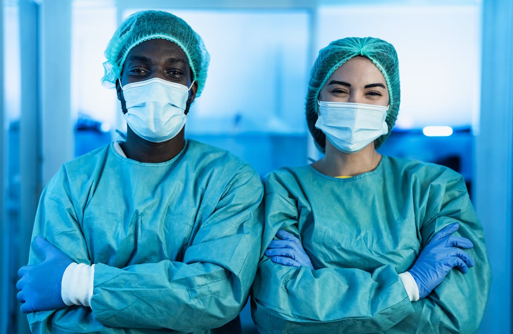 Two Multiracial Doctors Wearing Protective Equipment